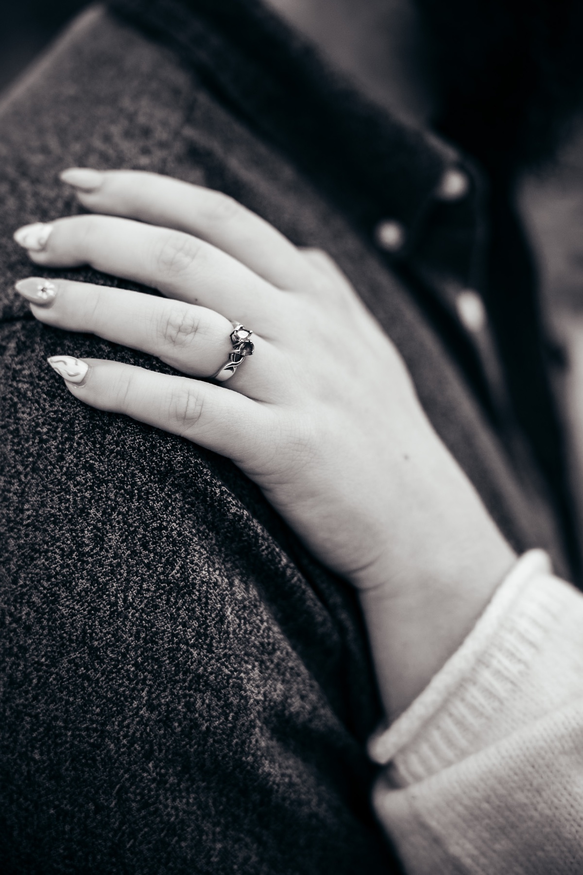 Adele's engagement ring, hand resting on Jack's shoulder